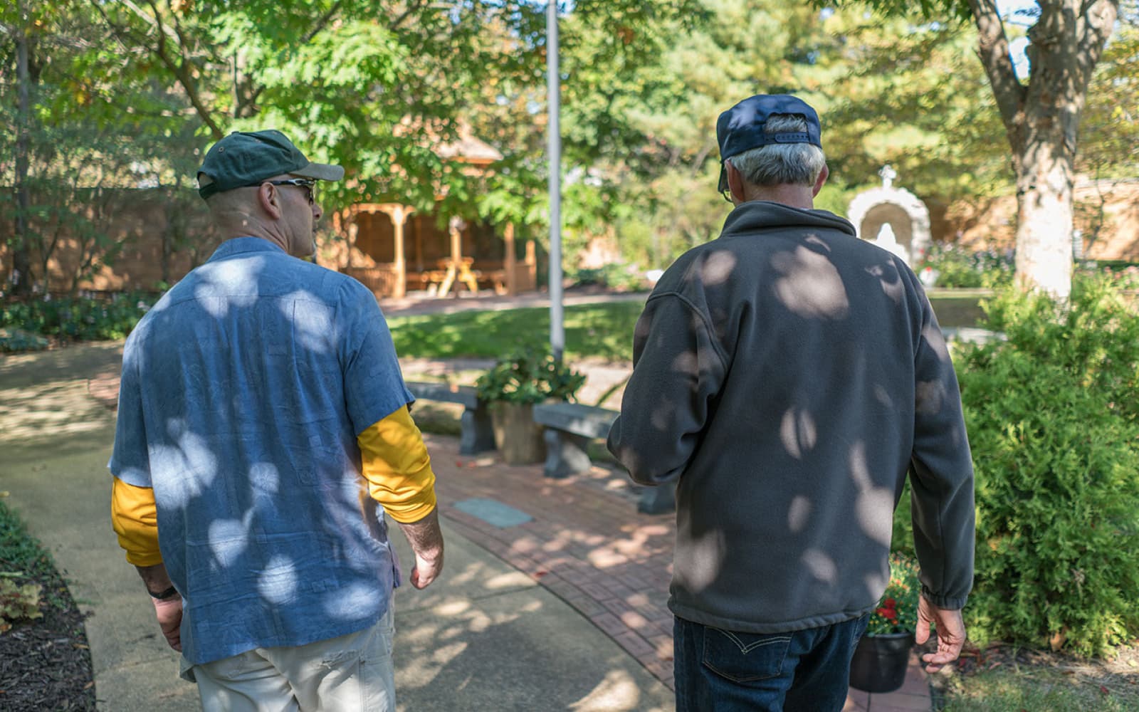 Two men walking through park